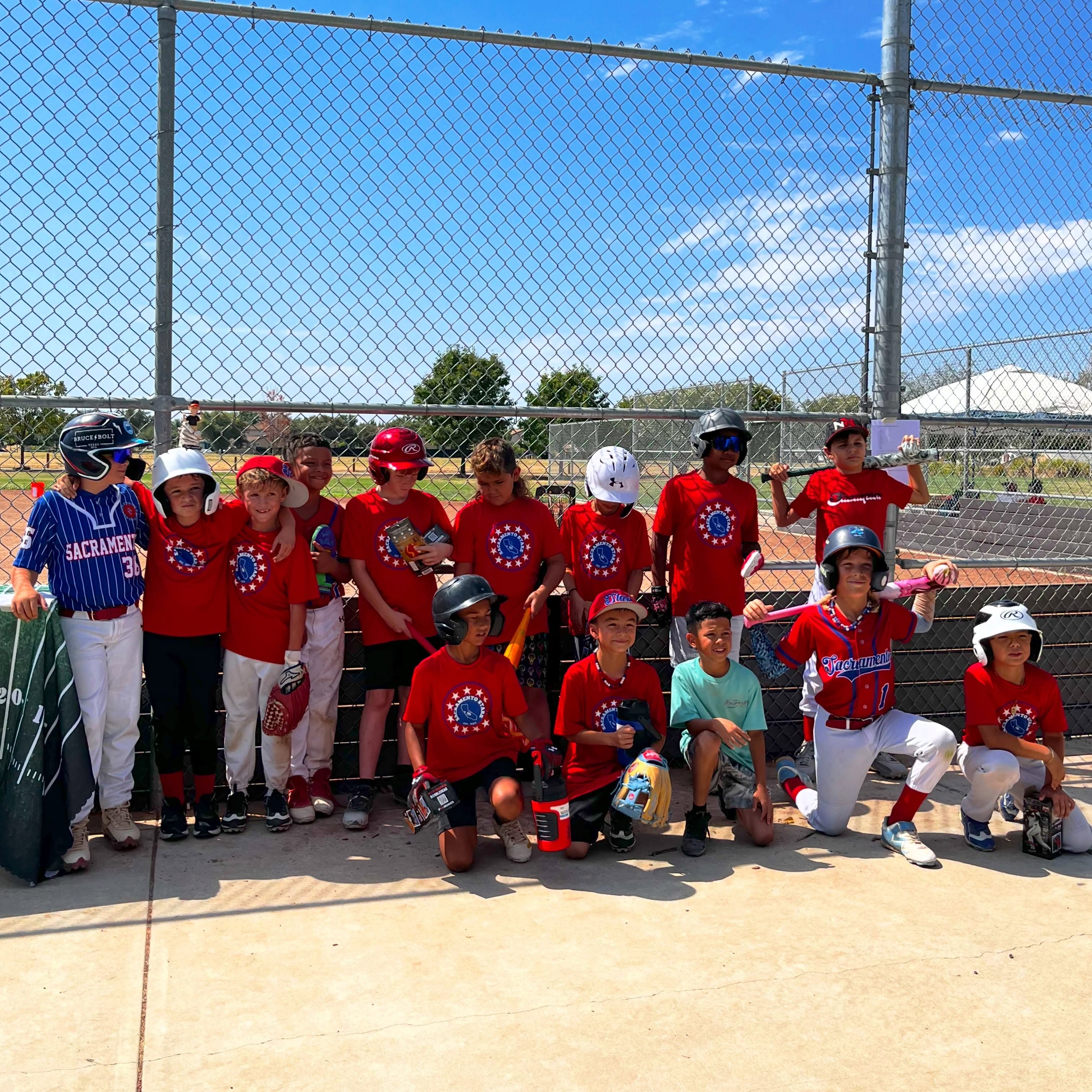 The Sacramento Stars team poses together along the fence after a day at the park.